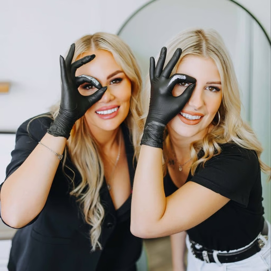 Two salon owners laughing together during a brand shoot