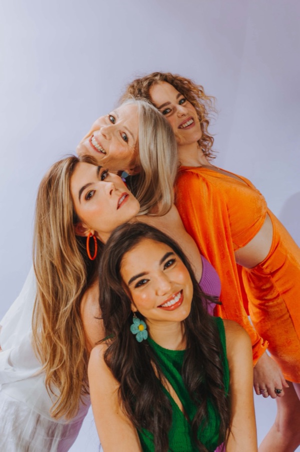Three women in bright colours photographed for a brand campaign