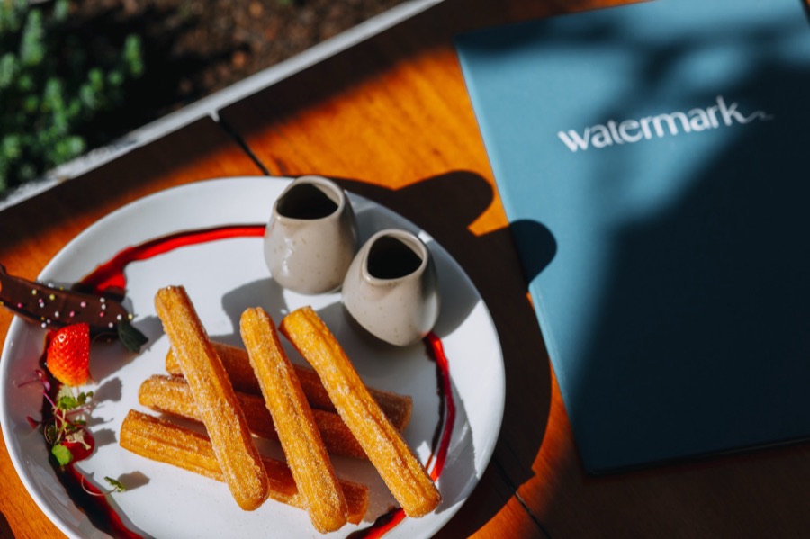 Churros and coffee plated for a cafe brand shoot